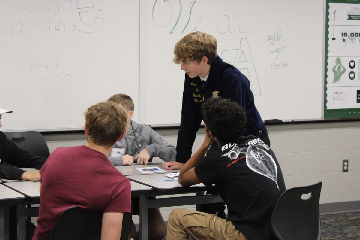 Grayson Marzen learning about FFA competitions with State Officer Cooper Vanderheiden.