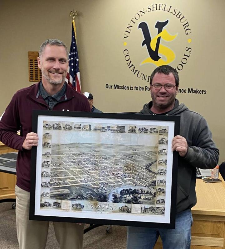 Andrew Elwick, presented the school district with four matted maps of Vinton