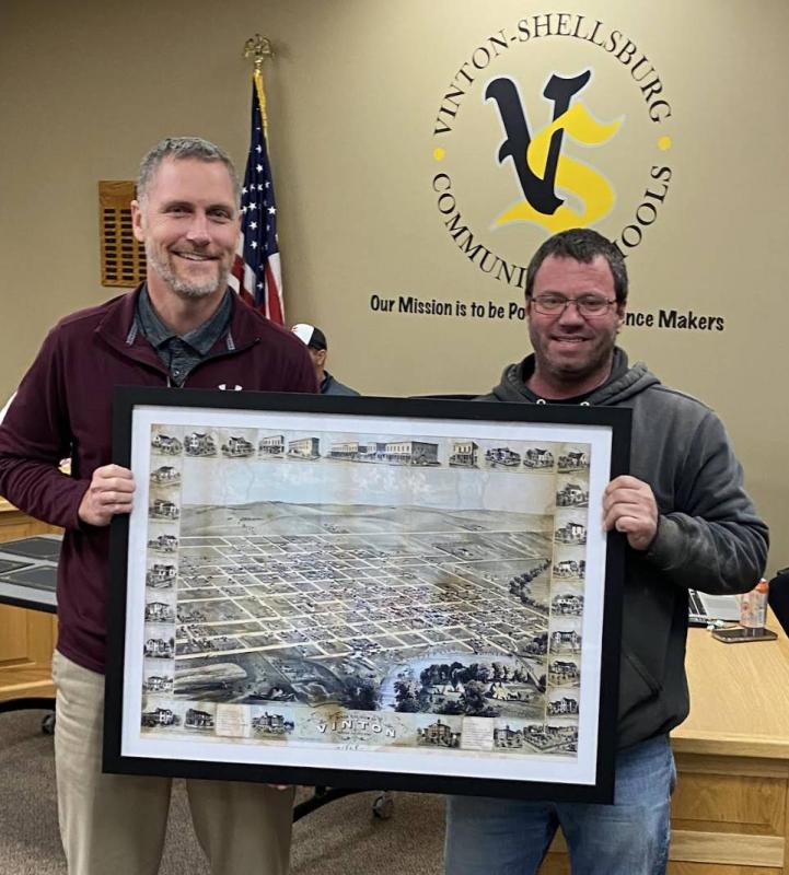 Andrew Elwick, presented the school district with four matted maps of Vinton