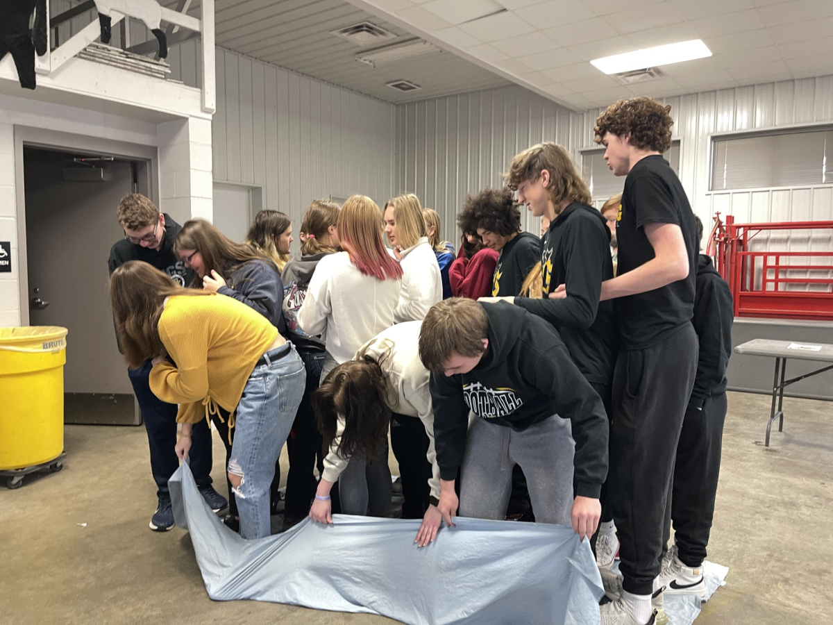 Ag 1 students attempt to keep everyone on while they flip over their