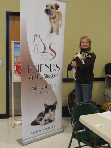 Julie Havran and Peeka display Friends of the Shelter's new sign