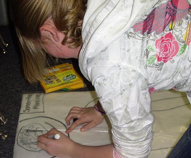 Caitlyn Martin works on a display showing ancient Egyptian medical theories.