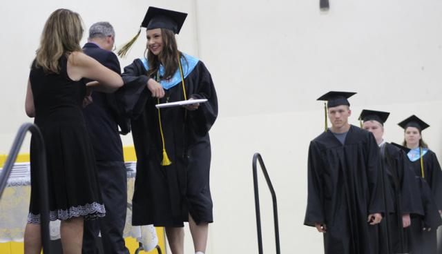A congratulatory elbow bump was customary at the 2020 graduation ceremony this year