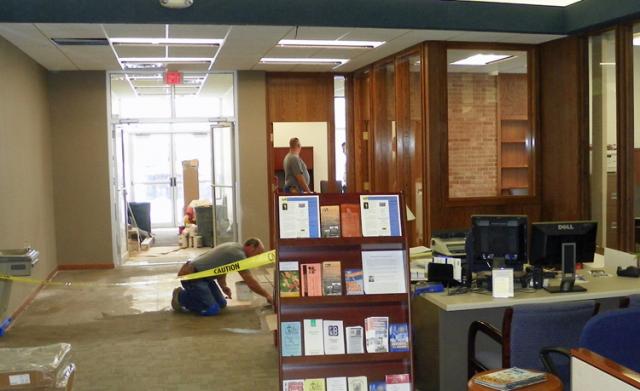 Carpet layers expected to finish their work Tuesday at Farmers Savings Bank & Trust-Vinton.