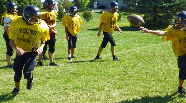 Sophomore backfield members work on pitch drills Thursday.