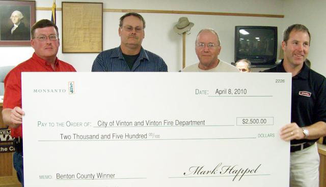 Fire Chief McKenna, Mark Happel, Mayor Watson accept $2,500 check from Monsanto's Matt Blythe.