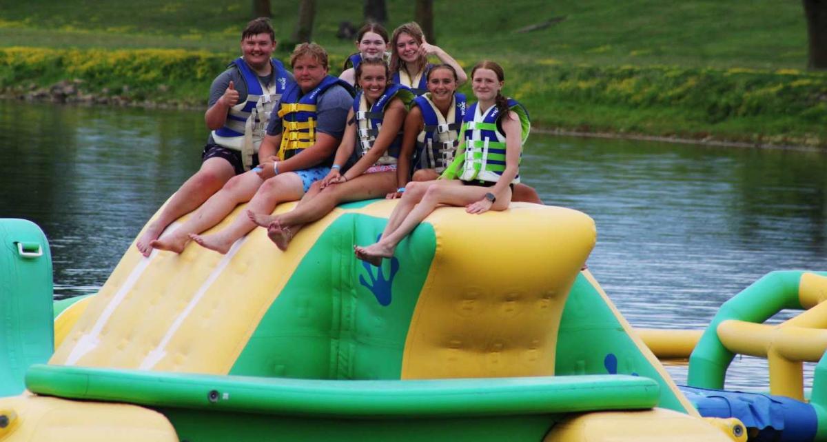 Will McKenna, Andrew Allsup, Madeline Pingenot, Bri Dulin, Kirsten Pettit, Maddie Bunten, and Ciara Dods playing on the inflatable water course.