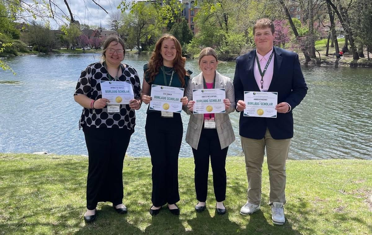 Bridgette Castle, Izzie Birker, Grayce McClintock, Andrew Pingenot holding their Norman Borlaug Scholarship certificates.