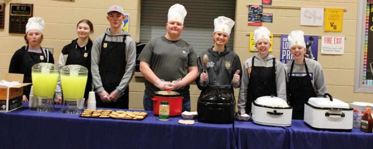 Carly Kreutner, Candice Kreutner, Will Kreutner, Andrew Allsup, Ciara Dods, Nora Grovert and Jenna Grovert helping serve food to the guests.    -- Gabby Power Agriculture Instructor/FFA Advisor Vinton-Shellsburg High School. Click to read article