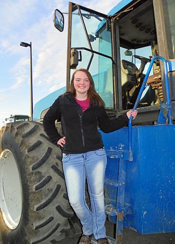 Emily Cashman, one of the VS FFA reporters, poses on a tractor Friday at VSHS.