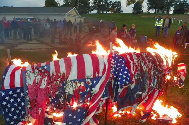 Scouts and veterans retired unserviceable flags Friday evening.