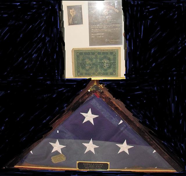 The flag and other items that honor the memory of WWII veteran Robert E. Clark.