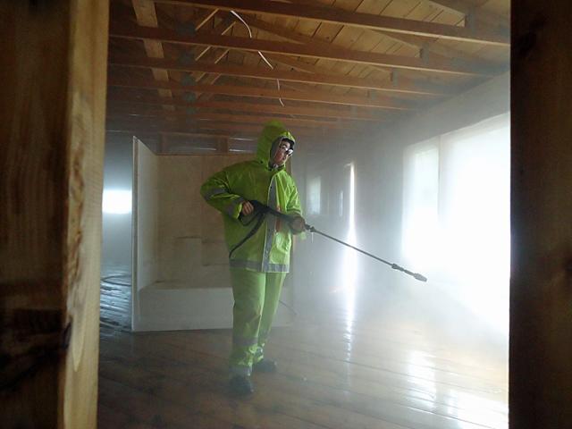 Maple 2 member Hailey power-washes the walls of a home affected by the Minot flooding.
