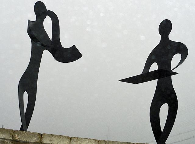 The metal sculptures at Celebration Park stand in contrast to the fog Tuesday morning in Vinton.
