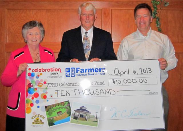 FSB President Darlys Hulme & CEO William C. Talen present a Celebration Park check to Jeff Peterson.