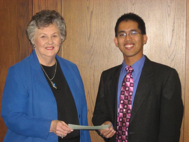 Darlys Hulme presents a check to Eric Mohlis to benefit the Vinton Shellsburg music program.