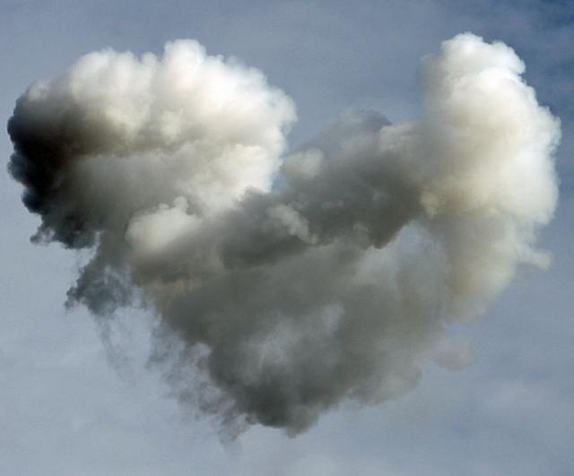 Smoke from an early evening Boomtown show forms the shape of a heart over the fairgrounds.