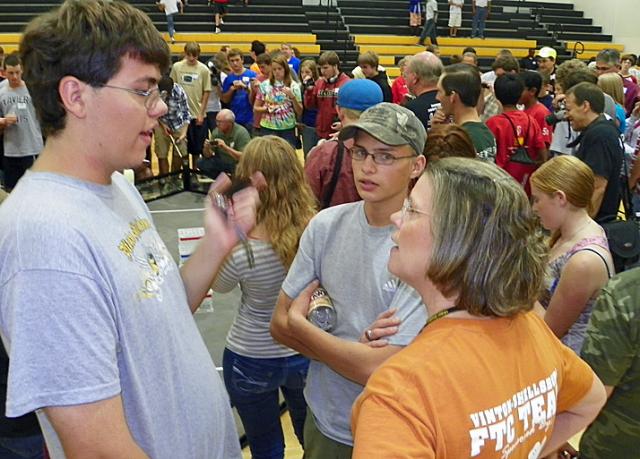 VS team members Nick Stout and Matthew Uthoff discuss the course with teacher Marsha Furlong.