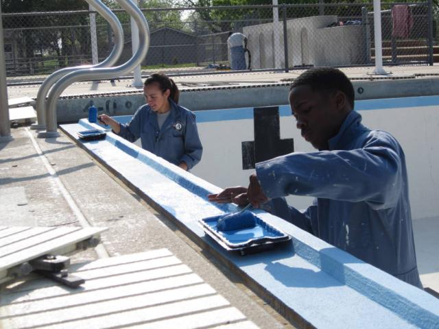 Maple 4 members Gaby Nieves & Gregory Day paint the Vinton pool's trim.