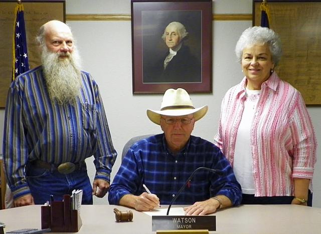 Jim Huber and Fran Stueck witness Mayor John Watson's Garden Week proclamation signing.