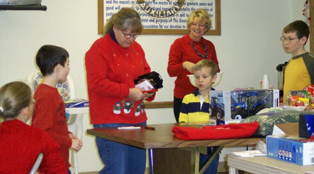 Michelle Oldfather and Pat Rausch draw names for the Annual Mount Auburn Christmas Party raffle.