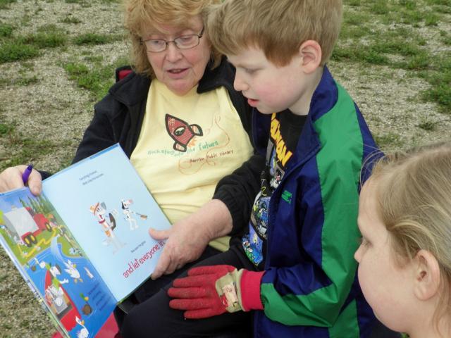 Garrison Library Board President Mavis Dickerson reads to children before the celebration begins.