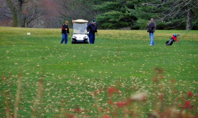 Area golfers went to the course on Monday, despite the chilly, windy weather.