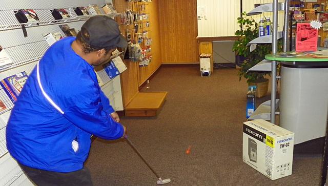 James Stevenson putts toward the computer hole at RJ Ender Computers.