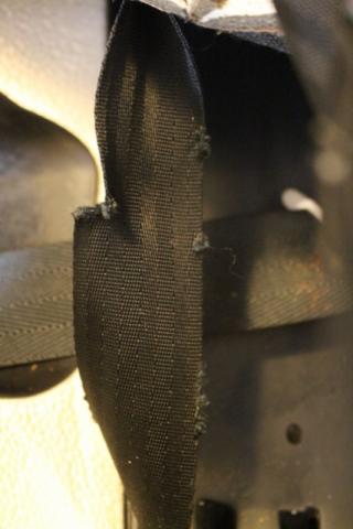 close-up of damaged car seat strap