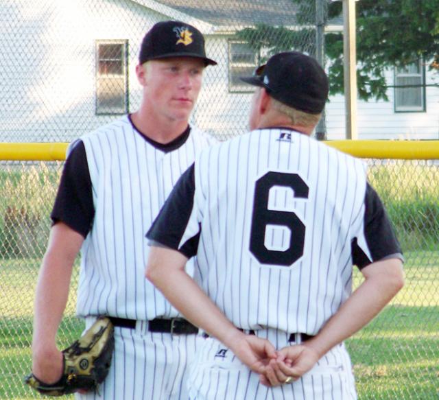 Gunner Tranel and coach Jim Struve discuss pitching strategies during Solon game in Vinton.