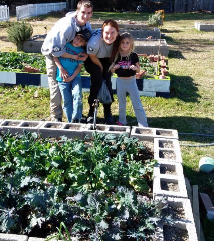 Brenden & JJ of Hickory 4 make new friends with volunteers at Harvesting Hope Community Garden.