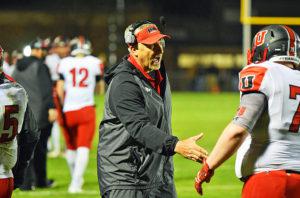 Coach Hadachek congratulates lineman Liam Stone 