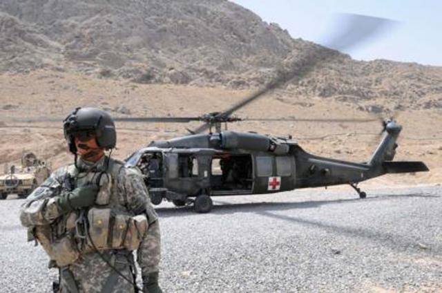 A helicopter awaits to transport an injured eastern Iowa Marine in Afghanistan.