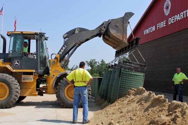 Crews have begun removing the Hesco flood barriers.