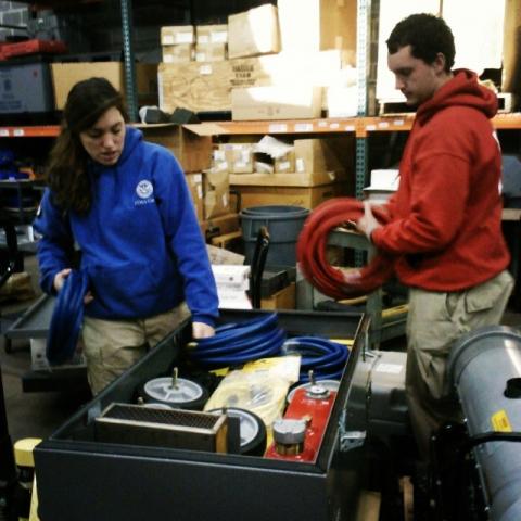 Team leader Mike & member Ali organizing a water heater kit.