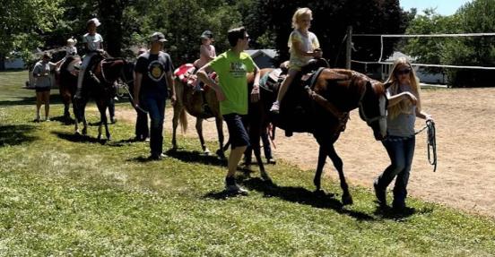 FFA members guided horses and walked along kids for safety during the horse rides.