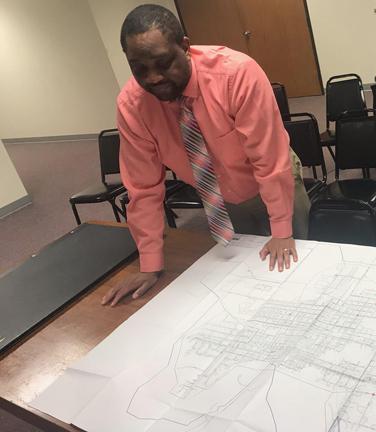 City Administrator Chris Ward examines the map of the planned route for the network fiber optics