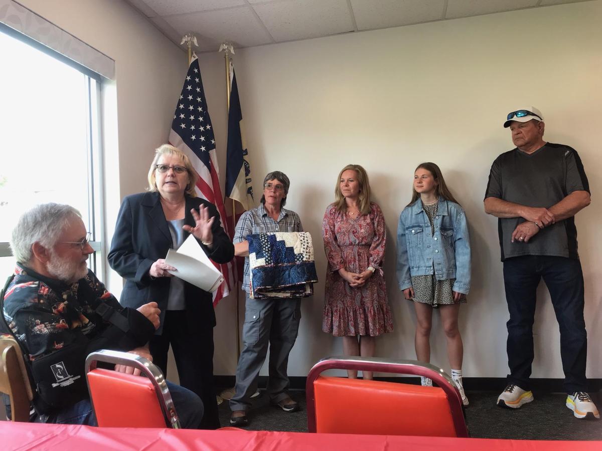 Teresa Bednar-Schadle presenting the program for the Quilts of Valor