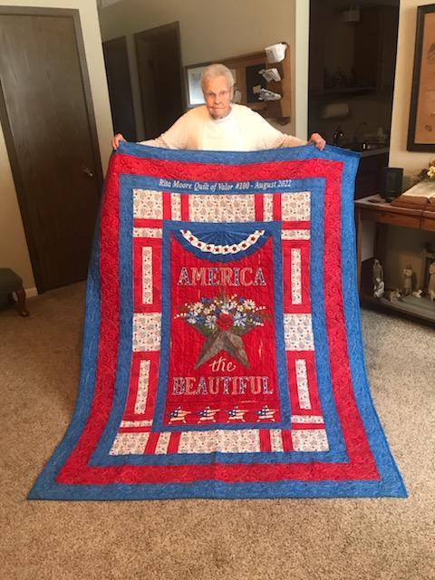 Rita Moore with her 100th Quilt sewn for the Quilts of Valor program