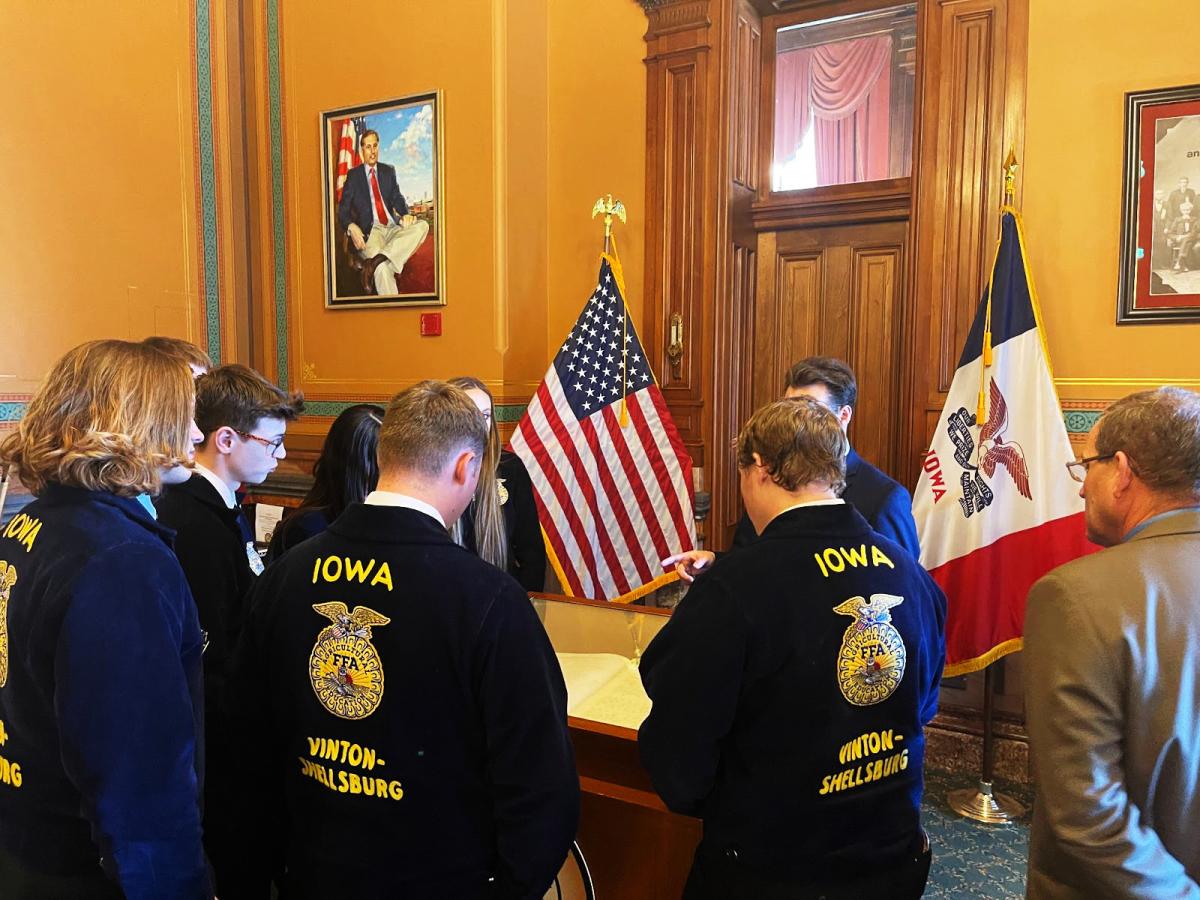 Members looking at the Iowa Constitution and learning cool facts about it.
