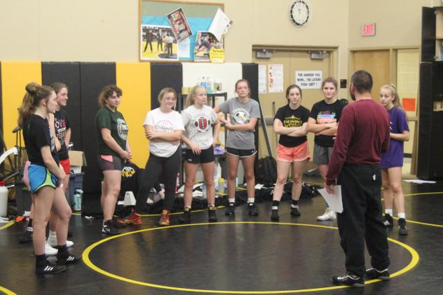 V-S wrestling coach Brian Sheston (right) addresses the Vikette wrestlers before practice Thursday.