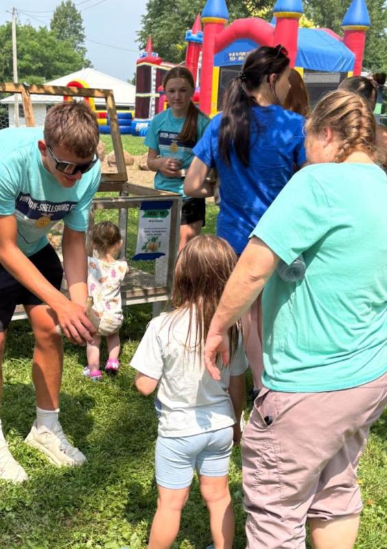 Levi Lutz and Zoey McClintock handing out ducks and chicks to kids.