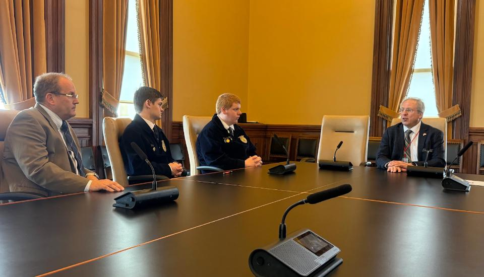 Chad Newton, Ben Buhr, and Braedon Hepker meet with Representative Thomas Gerhold.