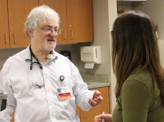 Dr. Sheff discusses an issue with Chelsea Erhardt, VGH social worker