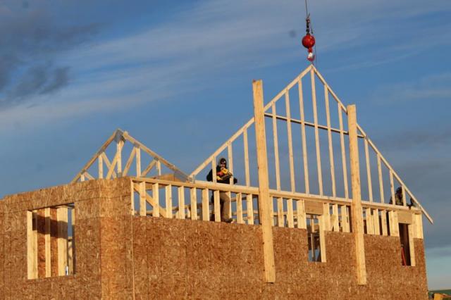 Jeremy Grimm of Grimm Construction secures a rafter on the first home in Anderson Creek Estates