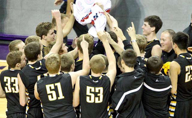 The Vikings and Coach J celebrate with the State Tournament banner after winning Sub-State game.