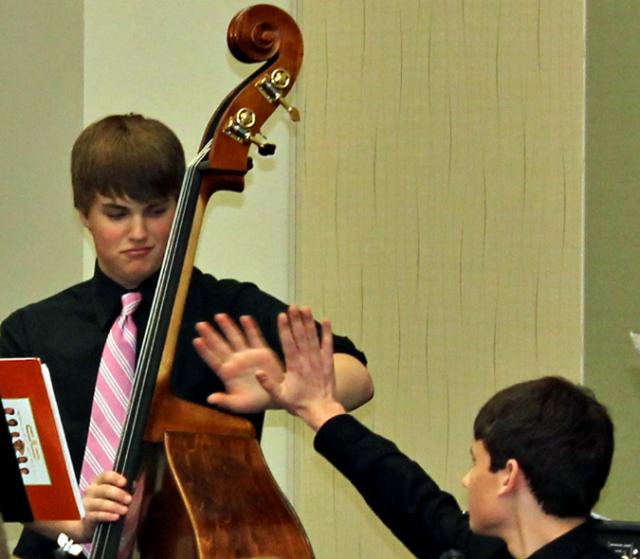 Caleb Bendull and Lucas Murray exchange high fives after the VS Jazz Band ended its performance.