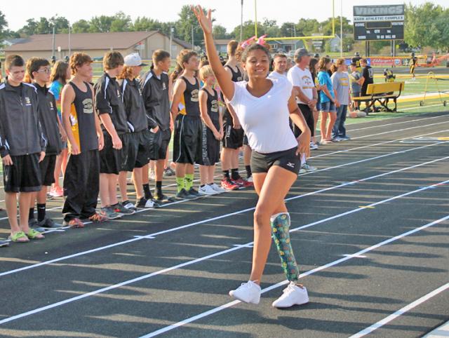 Kay Mull waves to the crowd during the Fall Blow-Out. She has overcome several health issues.