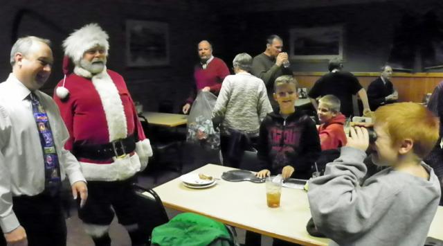 After opening their gifts, children began playing with them during the Kiwanis Christmas event.