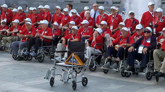 An empty wheelchair with Keith Mossman's photo and a flag honored the late WWII vet from Vinton.